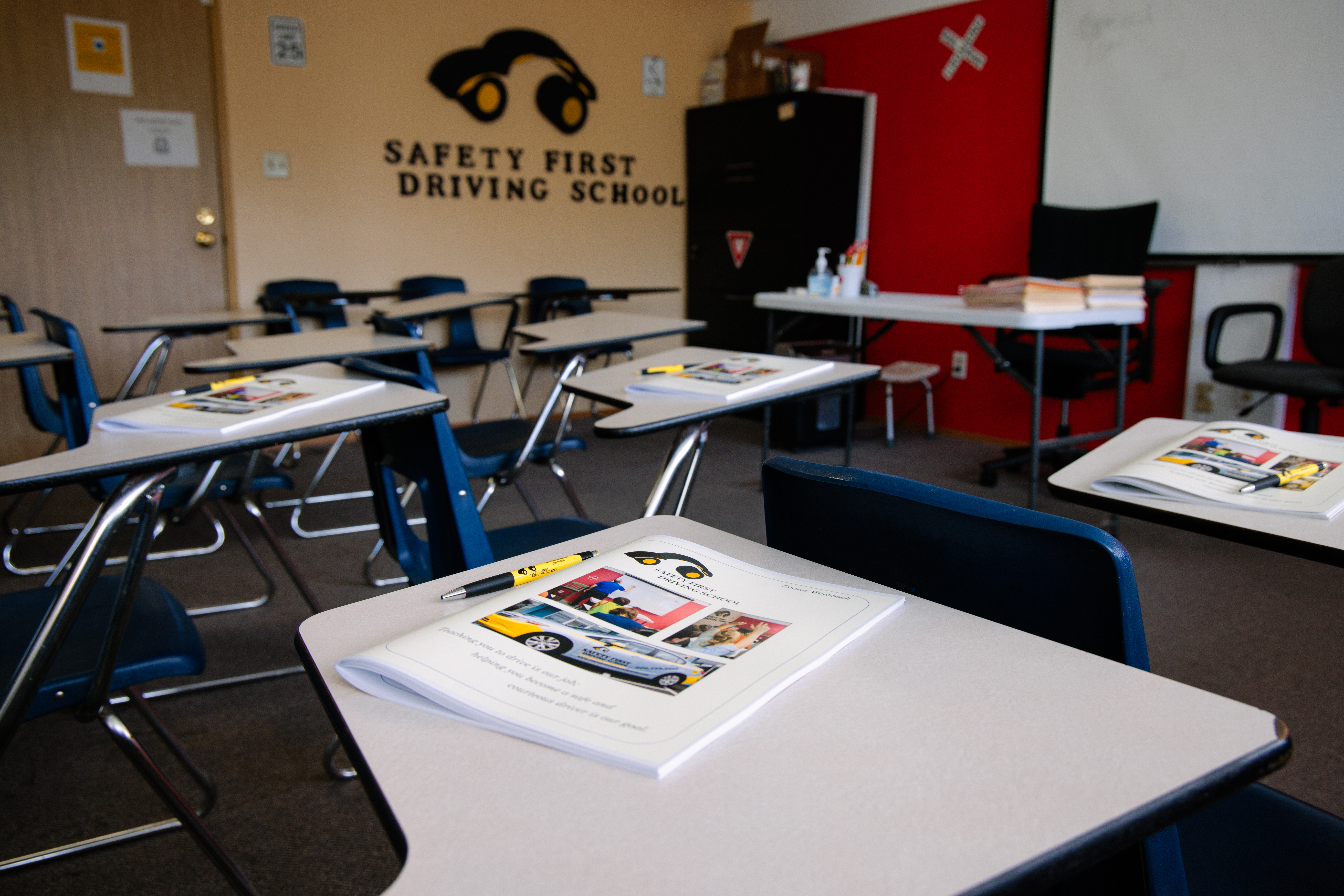 Visual of classroom featuring desks and a "Safety First" sign